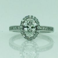 SR4643HN 18CT WG DIAMOND CLUSTER WITH OVAL DIAMOND IN CENTRE RING