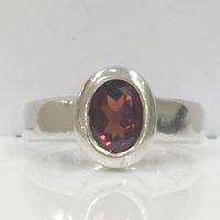 RING108 SILVER BEZEL SET OVAL GARNET RING
